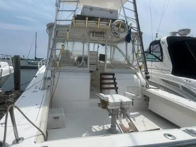 Slide: The Image of 2002 Jersey 36 Express boat docked at marina. - 5