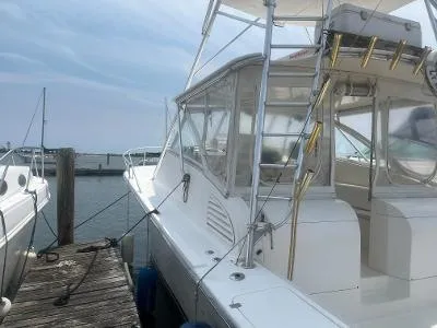 Slide: The Image of 2002 Jersey 36 Express boat docked at marina. - 6