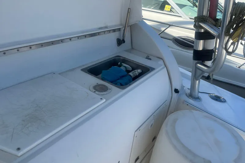 Slide: The Image of 2002 Jersey 36 Express boat deck with storage compartment and railing. - 70