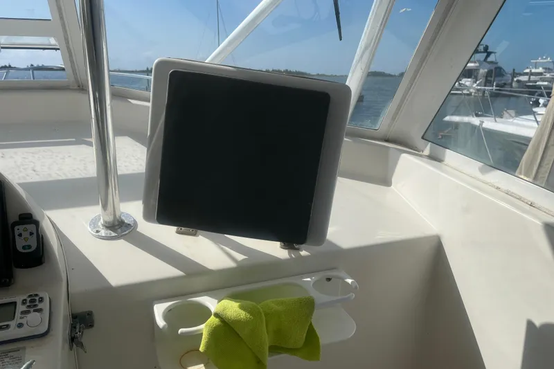 Slide: The Image of 2002 Jersey 36 Express boat cockpit with navigation screen and green towel. - 71