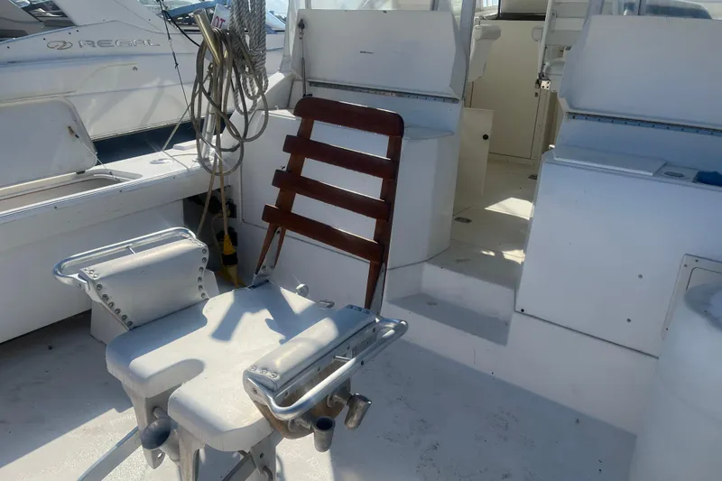 Slide: The Image of 2002 Jersey 36 Express boat interior with fishing chair and equipment. - 73
