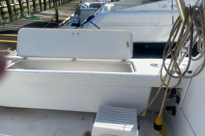 Slide: The Image of Open storage compartment on 2002 Jersey 36 Express boat docked at marina. - 74