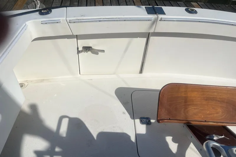 Slide: The Image of 2002 Jersey 36 Express boat deck with wooden seat and storage compartment. - 76