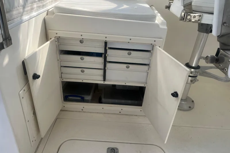 Slide: The Image of Open storage cabinet on 2002 Jersey 36 Express boat with organized drawers and containers. - 79