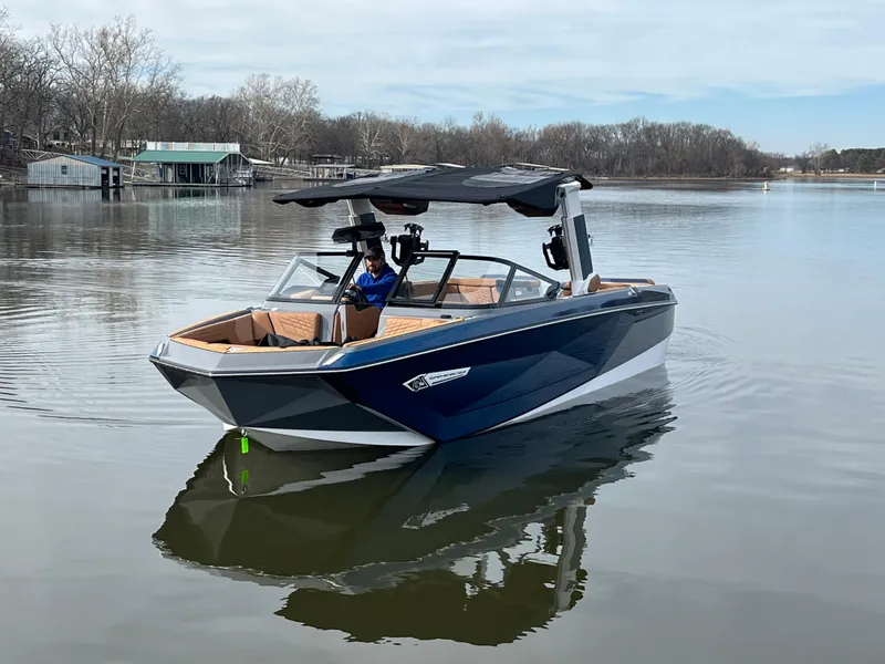 Slide: The Image of 2023 Nautique Super Air Nautique G25 on a calm lake. - 1