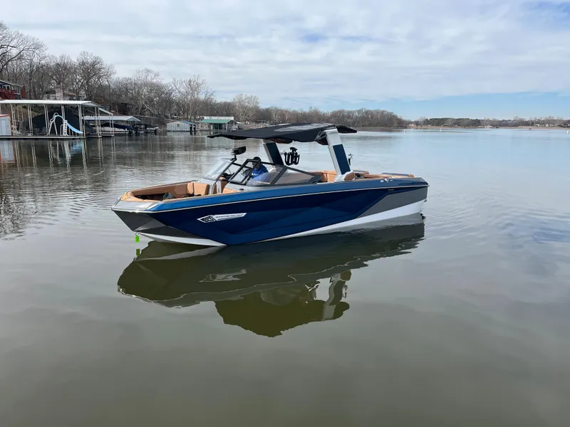 Slide: The Image of 2023 Nautique Super Air Nautique G25 on a calm lake. - 2