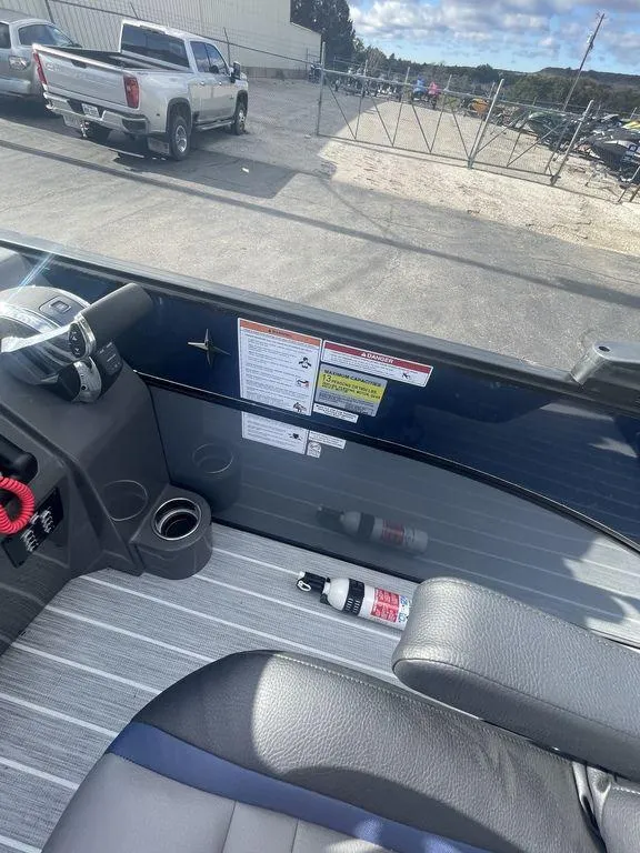 Slide: The Image of 2023 Berkshire 25UL STS 3.0 boat interior with steering wheel and safety equipment. - 12