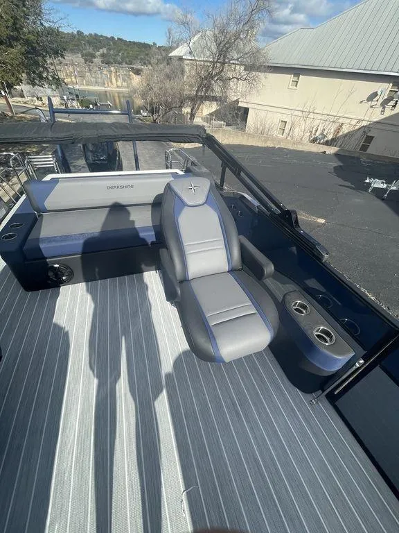 Slide: The Image of 2023 Berkshire 25UL STS 3.0 boat interior with gray seating and cup holders. - 15