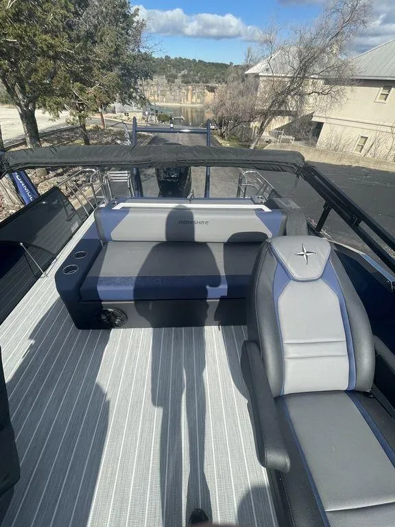 Slide: The Image of 2023 Berkshire 25UL STS 3.0 boat interior with seating, outdoors, sunny day. - 17