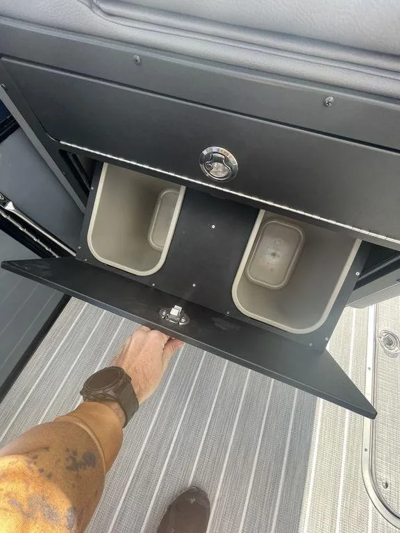 Slide: The Image of 2023 Berkshire 25UL STS 3.0 storage compartment with dual bins on a striped floor. - 9