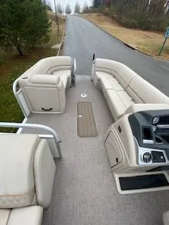 Slide: The Image of 2023 Ranger Reata 223C boat interior with beige seating and modern dashboard. - 4