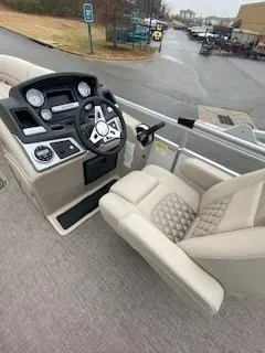 Slide: The Image of 2023 Ranger Reata 223C boat interior with steering wheel and plush seating. - 5