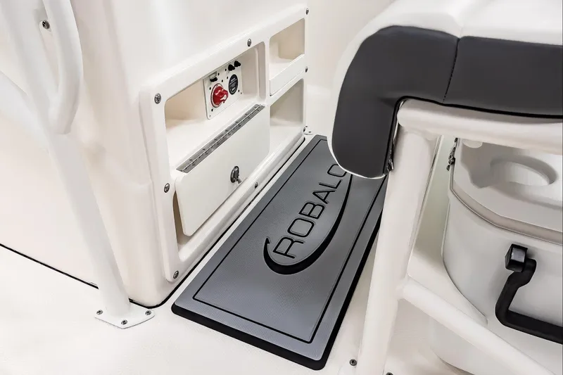 Slide: The Image of 2025 Robalo R200 Center Console interior with branded mat and storage compartments. - 12