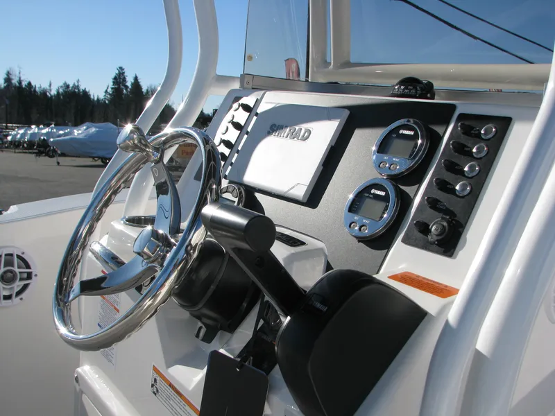 Slide: The Image of 2025 Robalo R200 Center Console boat dashboard with steering wheel and controls. - 4