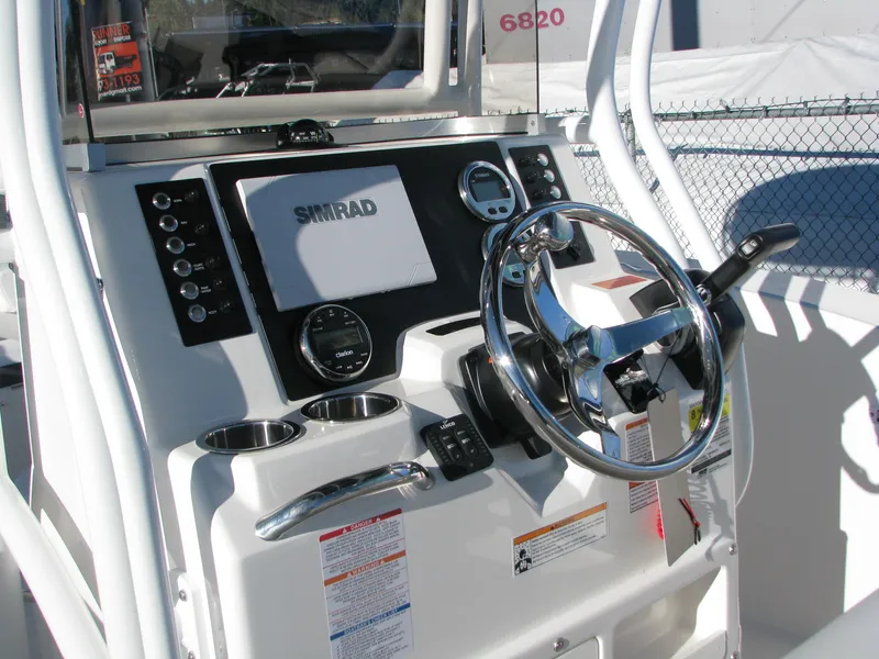Slide: The Image of 2025 Robalo R200 Center Console dashboard with steering wheel and navigation system. - 6