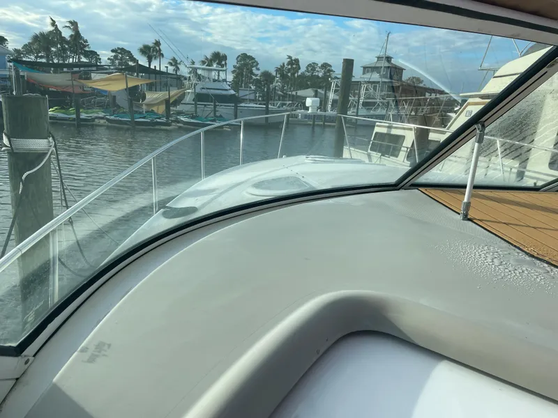 Slide: The Image of View from the helm of a 2004 Cruisers Yachts 320 Express docked at a marina. - 16