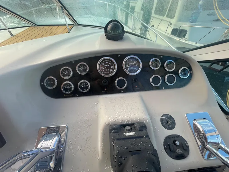 Slide: The Image of 2004 Cruisers Yachts 320 Express dashboard with gauges and controls. - 18