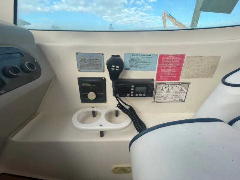 Slide: The Image of 2004 Cruisers Yachts 320 Express cockpit controls and communication equipment. - 19