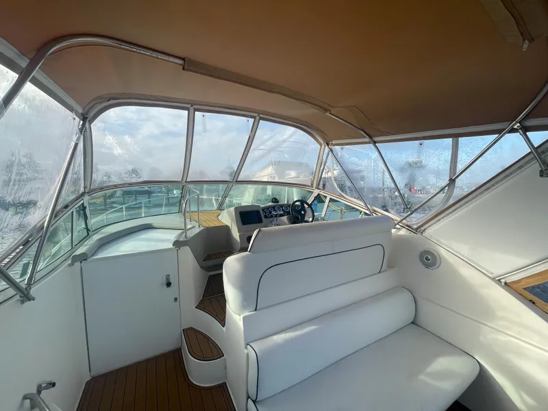 Slide: The Image of Interior of 2004 Cruisers Yachts 320 Express with helm and seating area. - 22