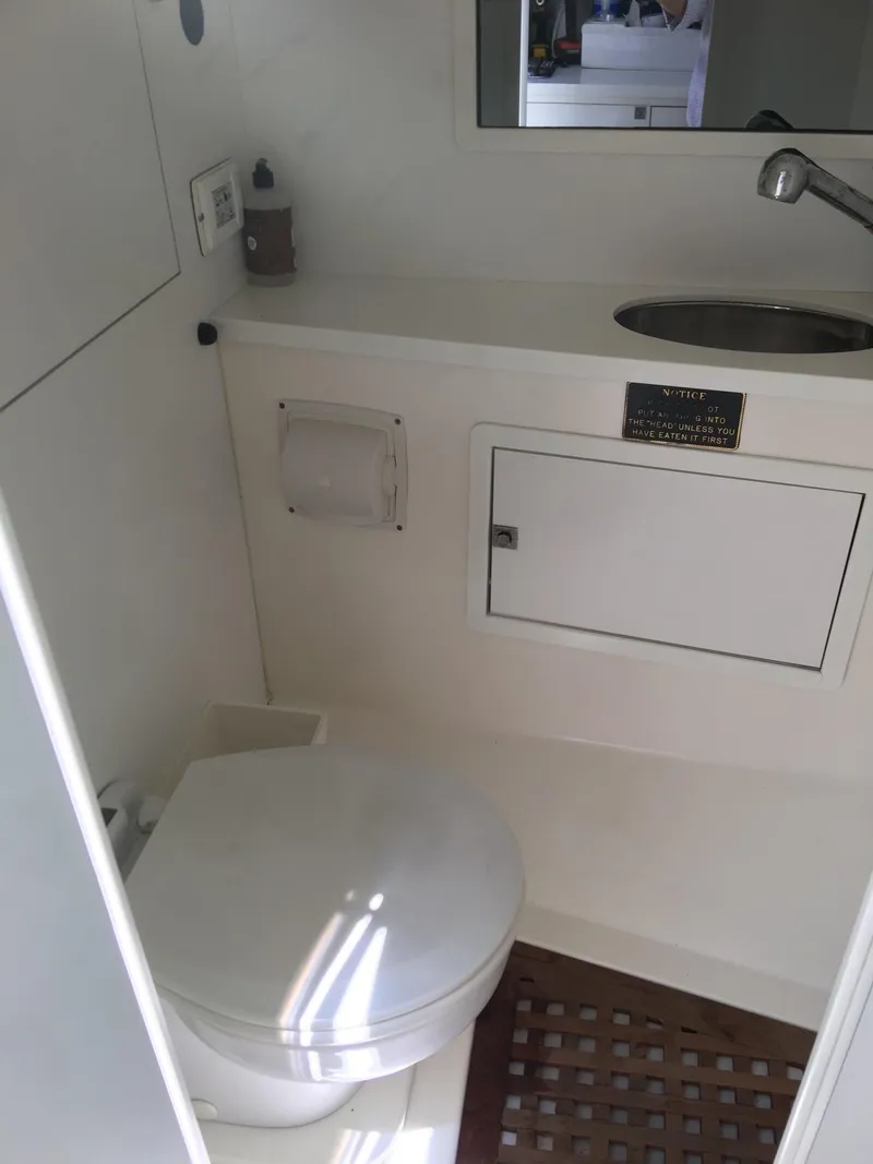 Slide: The Image of VanDutch 40 yacht bathroom interior, featuring a toilet, sink, and storage cabinet, 2010 model. - 15