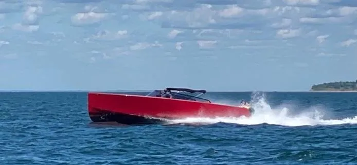Slide: The Image of Red 2010 VanDutch 40 yacht cruising on open water under a partly cloudy sky. - 3