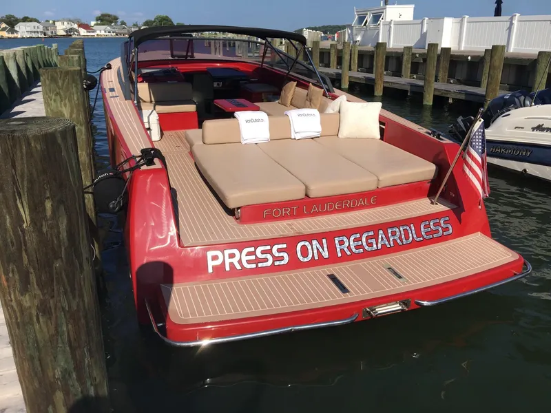 Slide: The Image of Red 2010 VanDutch 40 yacht docked, featuring "Press On Regardless" text on the stern. - 4