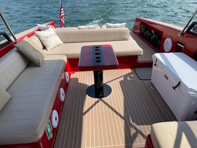 Slide: The Image of Luxurious 2010 VanDutch 40 boat interior with red and beige seating, table, and cooler. - 6