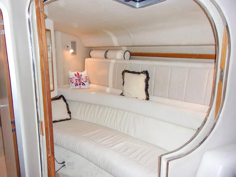 Slide: The Image of Cozy interior of 1992 Sea Ray 400 Express Cruiser with plush seating and decorative pillows. - 19
