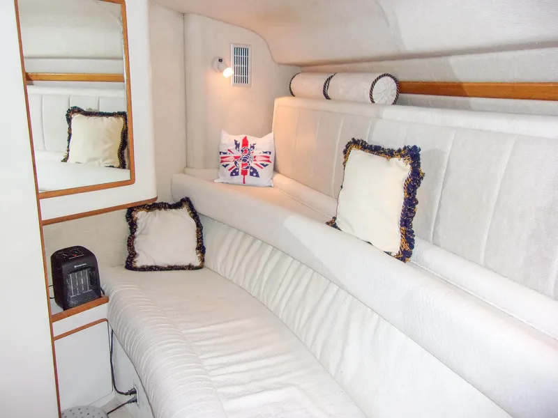 Slide: The Image of Interior of 1992 Sea Ray 400 Express Cruiser with white seating and decorative pillows. - 20
