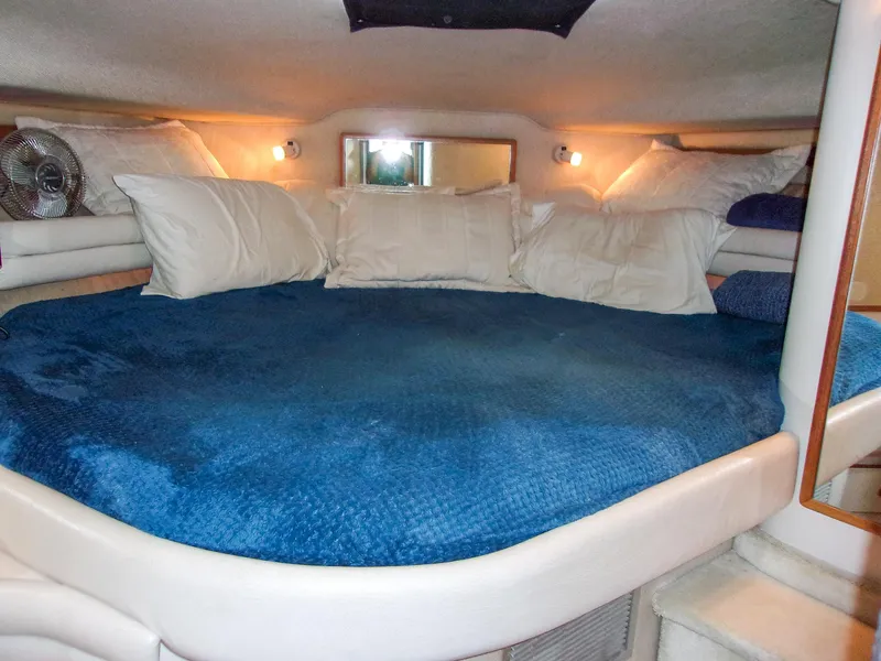 Slide: The Image of Cozy cabin interior of 1992 Sea Ray 400 Express Cruiser with plush bedding. - 22