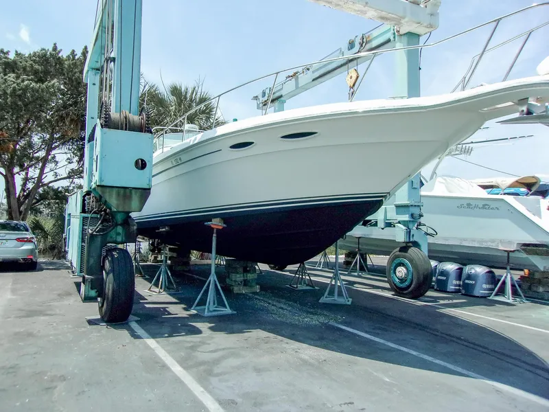 Slide: The Image of 1992 Sea Ray 400 Express Cruiser on dry dock, supported by stands. - 25