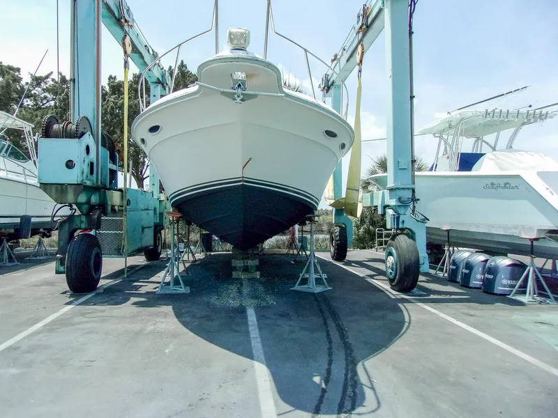 Slide: The Image of 1992 Sea Ray 400 Express Cruiser on boat lift in marina. - 26
