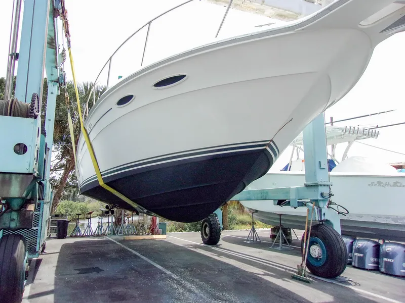 Slide: The Image of 1992 Sea Ray 400 Express Cruiser on lift, showcasing sleek hull design. - 28