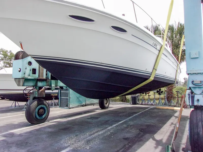 Slide: The Image of 1992 Sea Ray 400 Express Cruiser on a lift, showcasing hull design. - 29