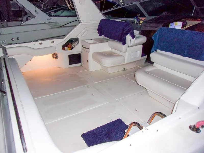 Slide: The Image of 1992 Sea Ray 400 Express Cruiser interior with white seating and ambient lighting. - 6
