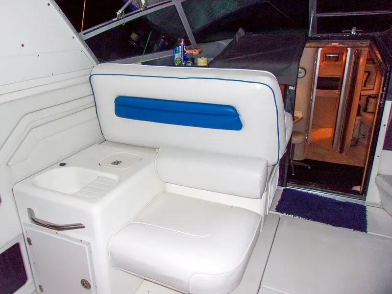 Slide: The Image of Interior of 1992 Sea Ray 400 Express Cruiser with white seating and sink. - 7