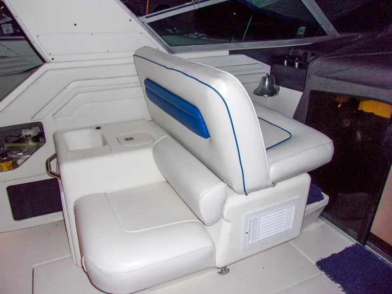 Slide: The Image of Interior seating of 1992 Sea Ray 400 Express Cruiser with white and blue upholstery. - 9