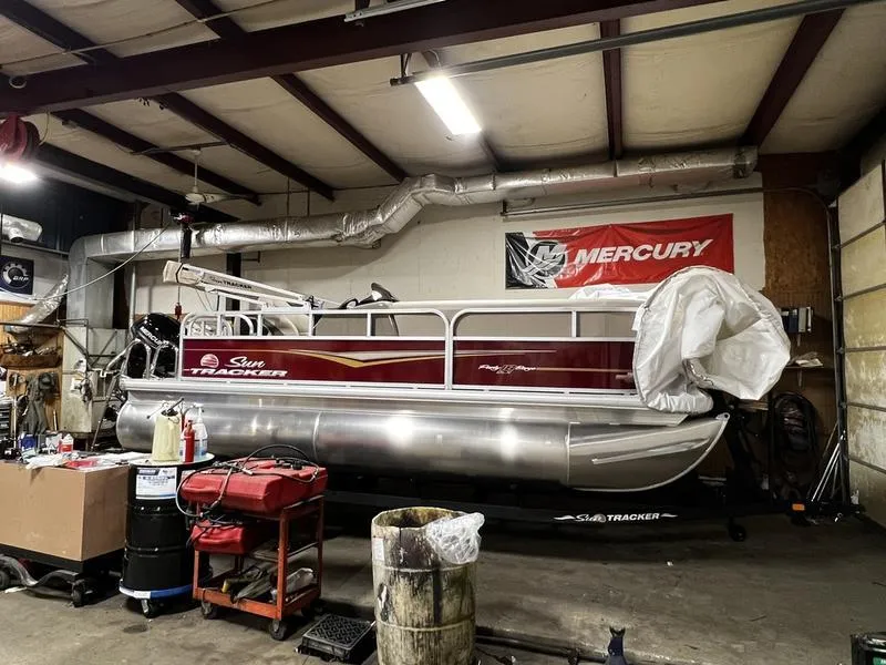 The Image of 2023 Sun Tracker Bass Buggy® 16 XL Select pontoon boat in a workshop. - 1