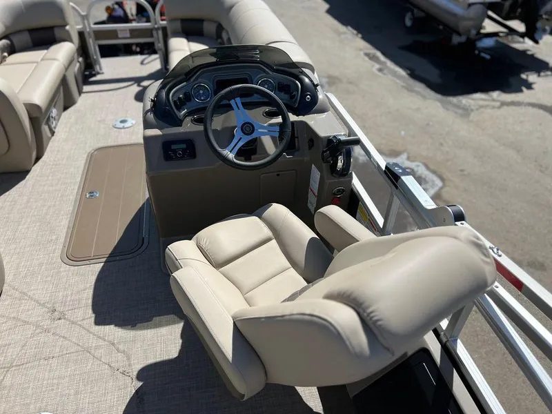 Slide: The Image of 2023 Sun Tracker SportFish™ 22 XP3 boat helm with beige captain's chair and control panel. - 11