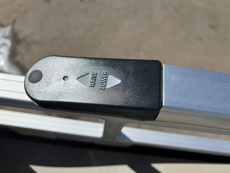 Slide: The Image of Close-up of 2023 Sun Tracker SportFish™ 22 XP3 control panel with raise and lower buttons. - 6