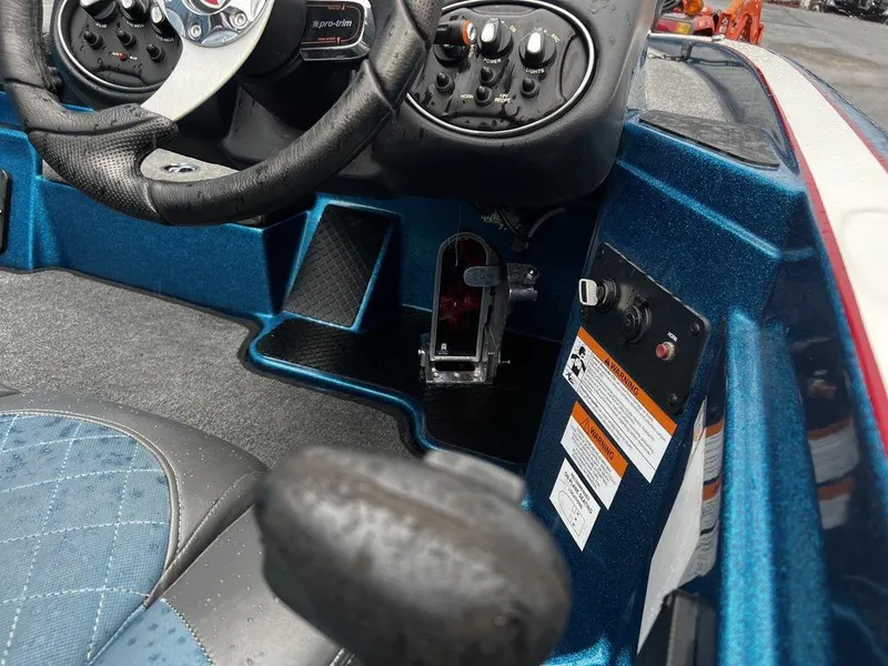Slide: The Image of 2017 Triton 19 TrX boat cockpit with steering wheel and control panel. - 10