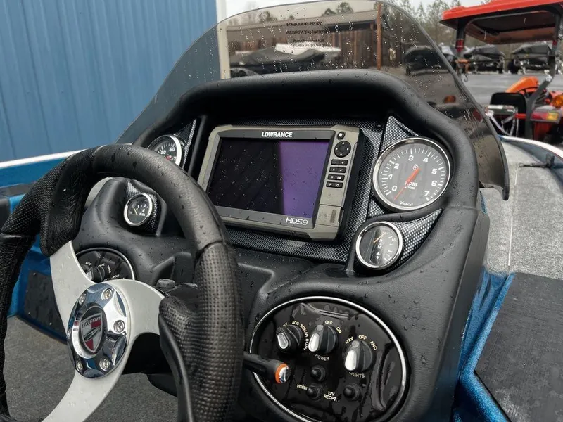 Slide: The Image of 2017 Triton 19 TrX boat dashboard with Lowrance GPS and gauges. - 2