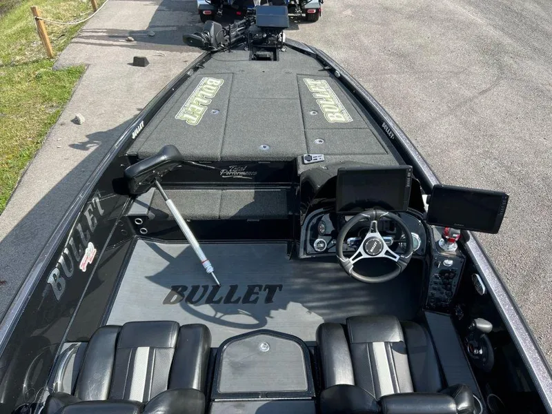 Slide: The Image of 2022 Bullet 21XRS boat interior with steering wheel and seating. - 4