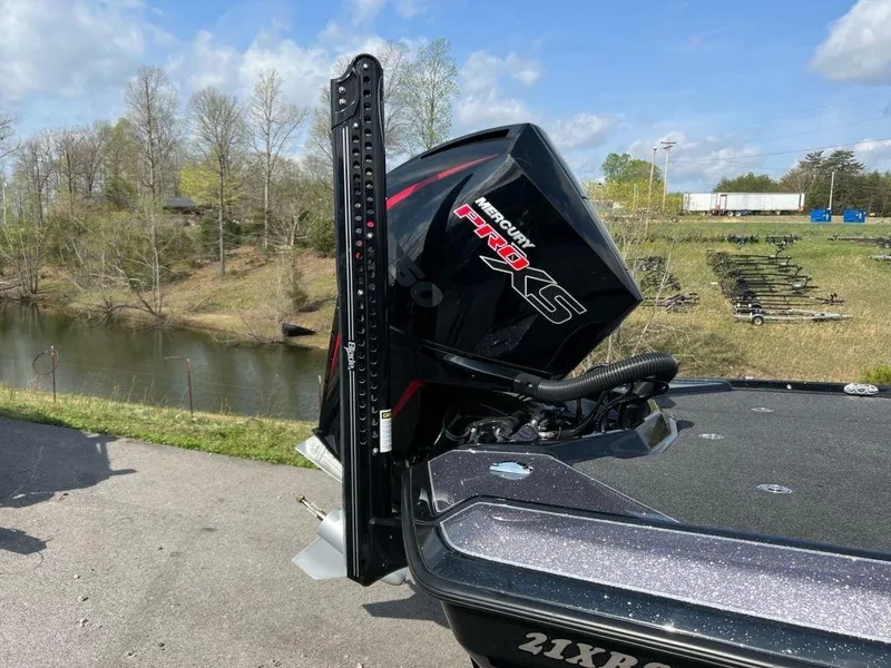 Slide: The Image of 2022 Bullet 21XRS boat with Mercury Pro XS engine by a scenic lake. - 6