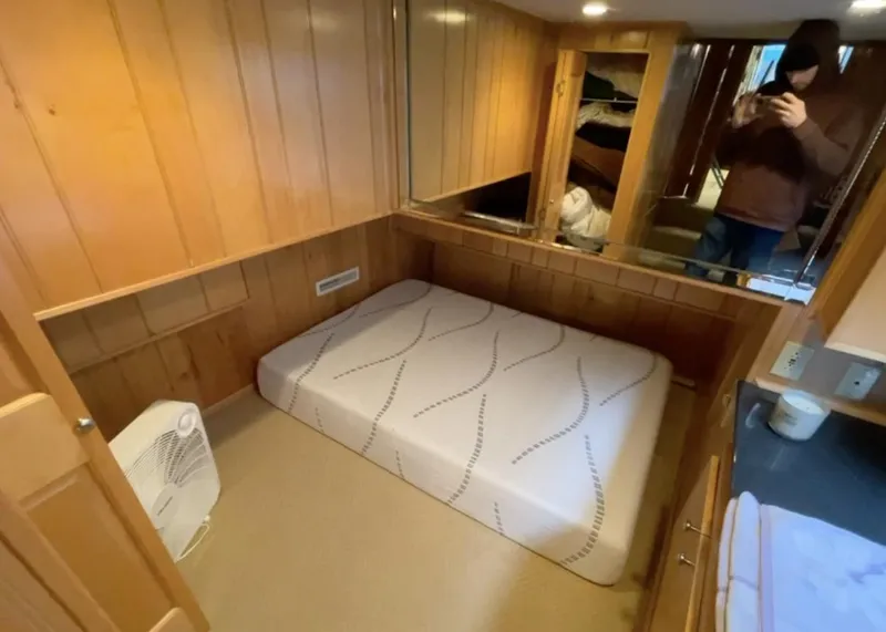 Slide: The Image of Cozy bedroom in 2000 Sumerset 16x75 houseboat with wood paneling and mirror. - 11