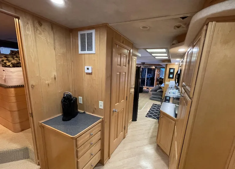 Slide: The Image of Interior of 2000 Sumerset 16x75 houseboat with wood paneling and modern amenities. - 14