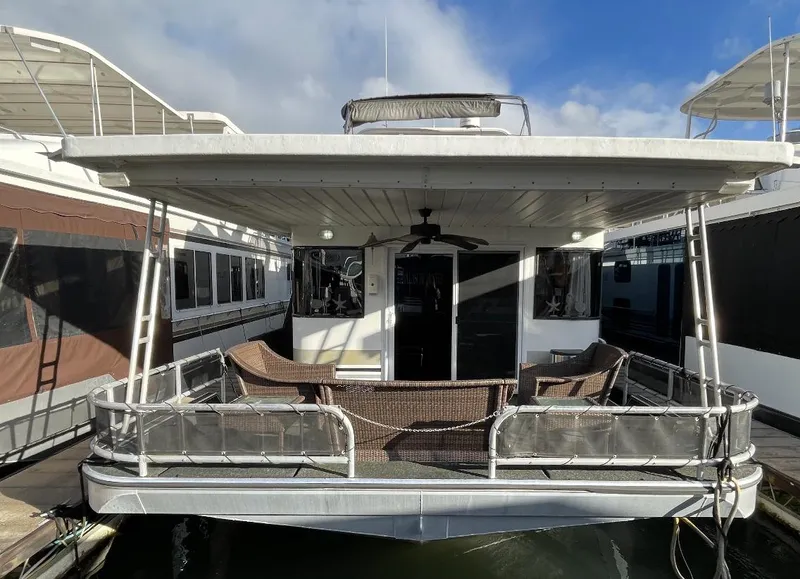 Slide: The Image of Sumerset 16x75 houseboat, year 2000, docked with outdoor seating area. - 2