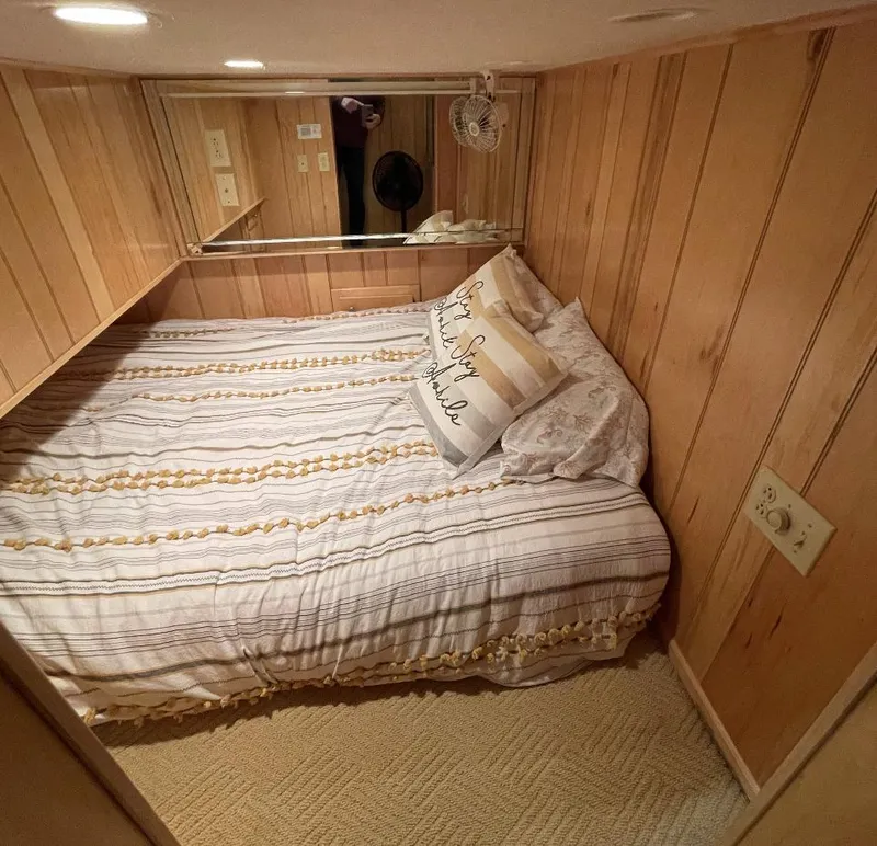 Slide: The Image of Cozy bedroom with wood paneling in a 2000 Sumerset 16x75 houseboat. - 20