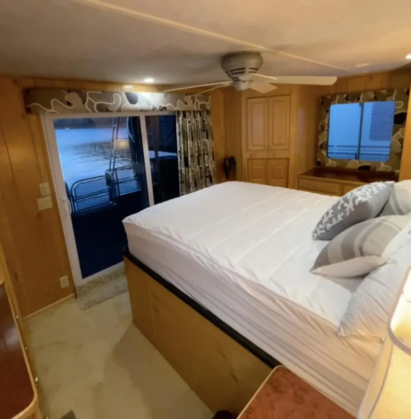 Slide: The Image of Cozy bedroom in 2000 Sumerset 16x75 houseboat with lake view and modern decor. - 22