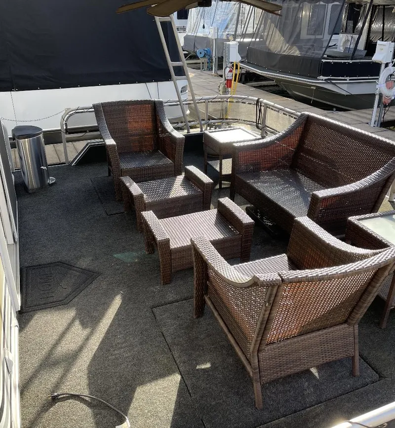Slide: The Image of Outdoor seating area on a 2000 Sumerset 16x75 houseboat with wicker furniture. - 4